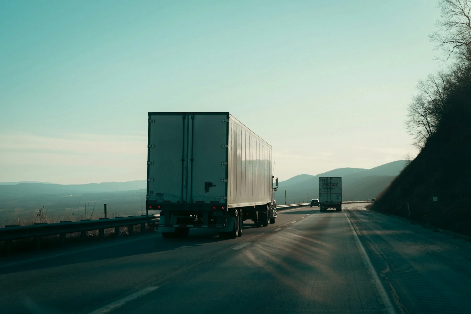 Commercial freight trucks traveling on a highway